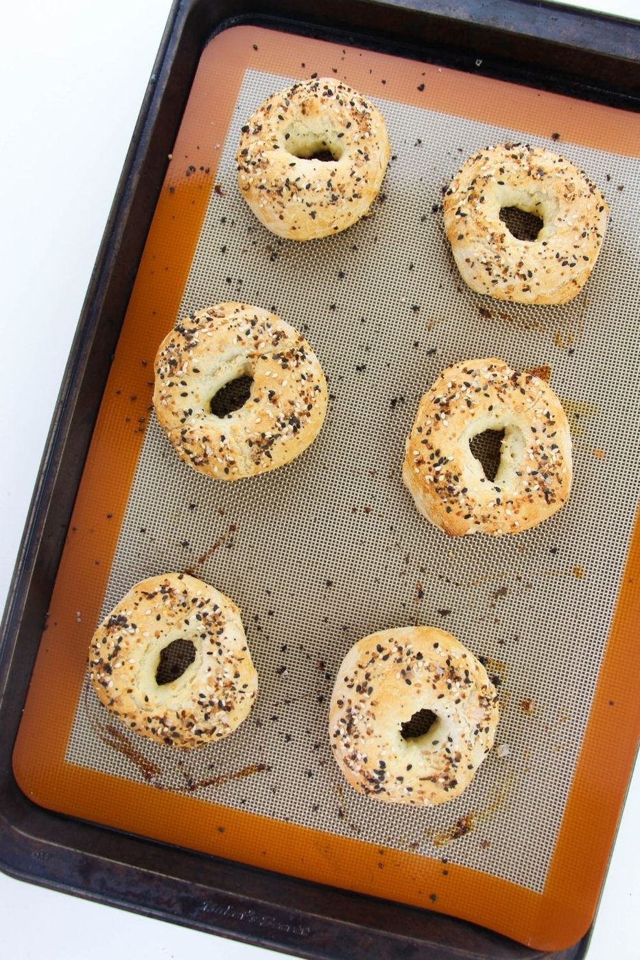 cooked bagels on cookie sheet