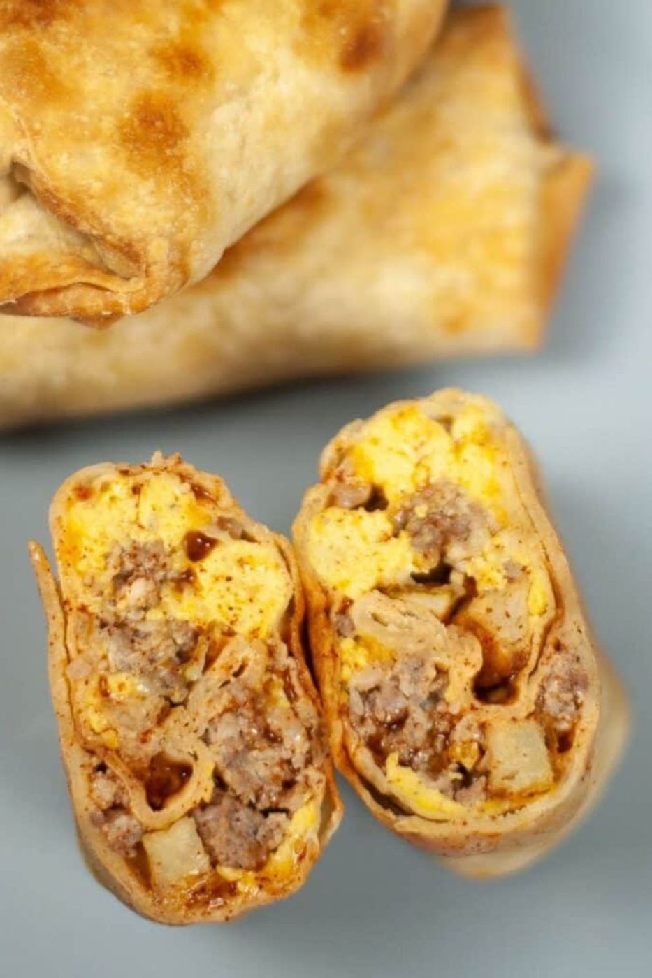 Air Fryer Breakfast Chimichanga cut in half to show the filling