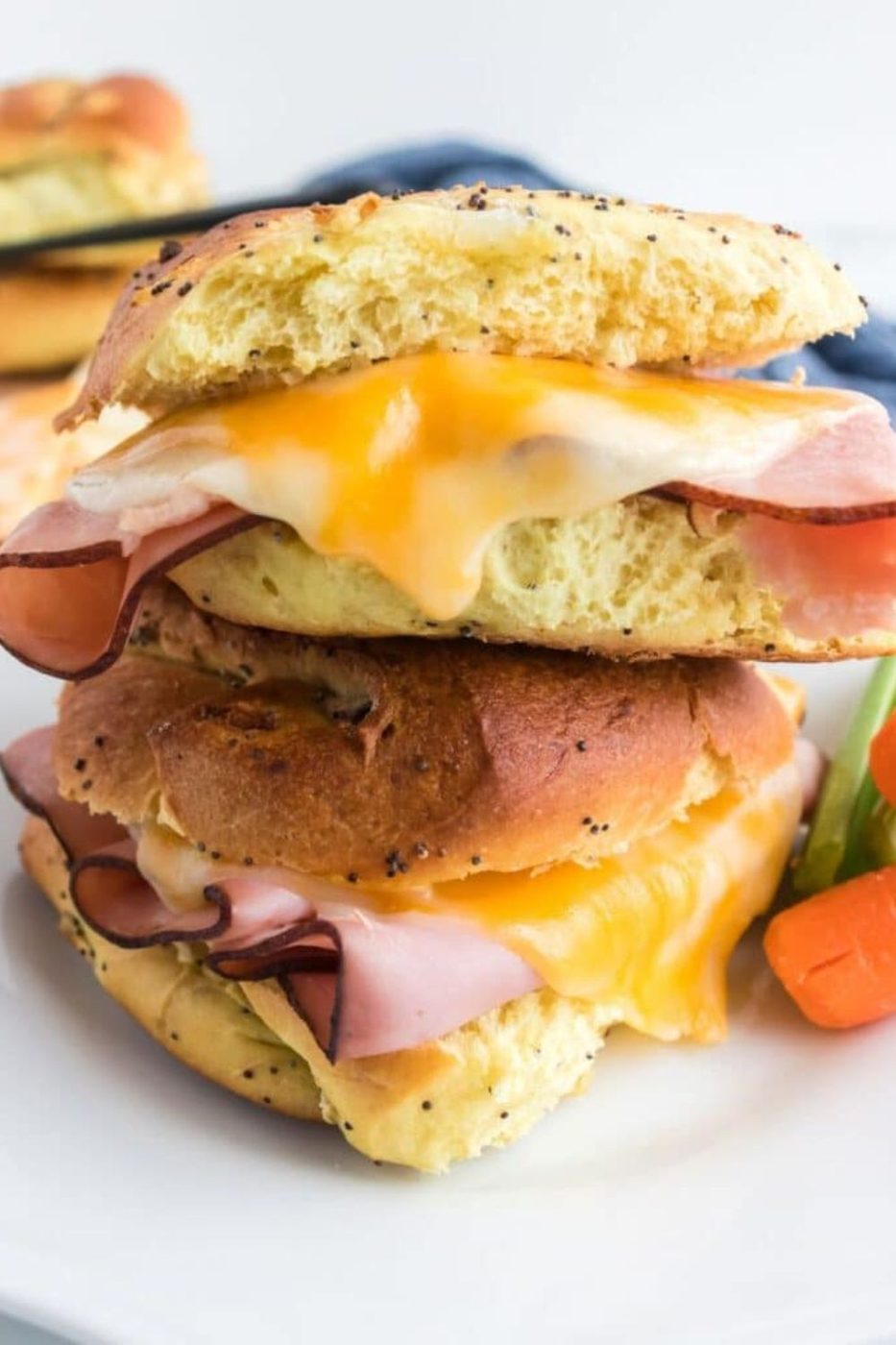Air Fryer Ham and Cheese stacked on top of each other on plate with carrots and celery to side 