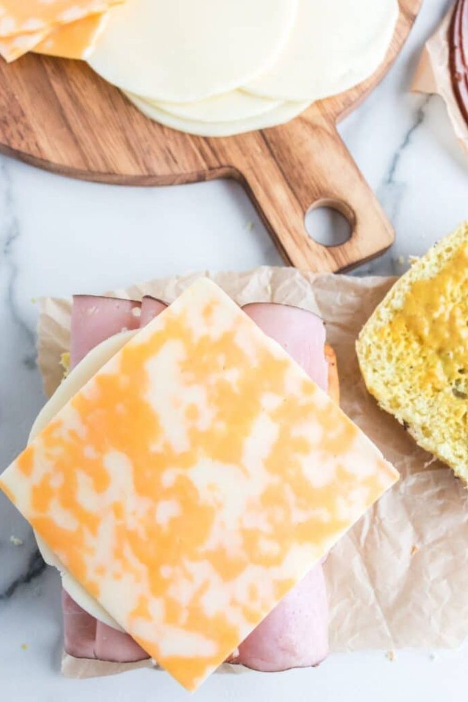assembling a ham and cheese sandwich 
