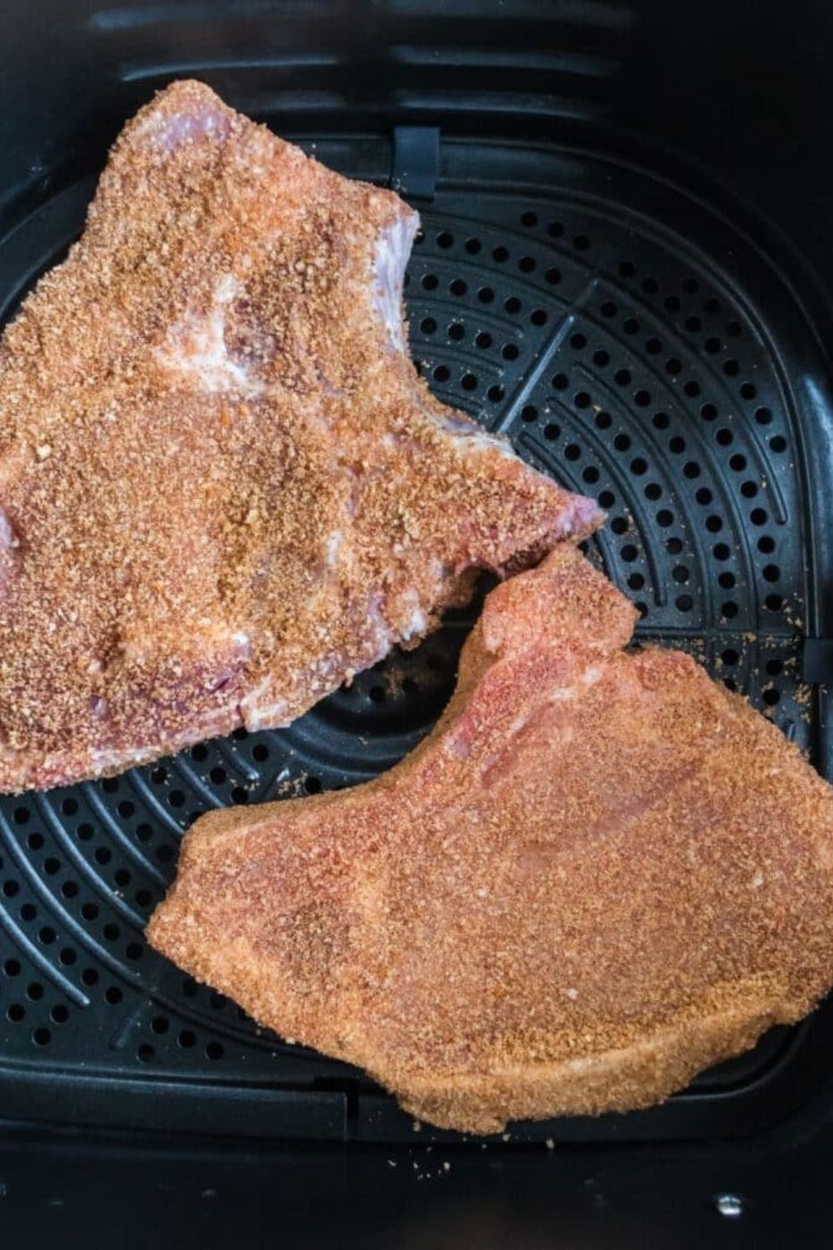 Air Fryer Shake and Bake Pork Chops in an air fryer basket