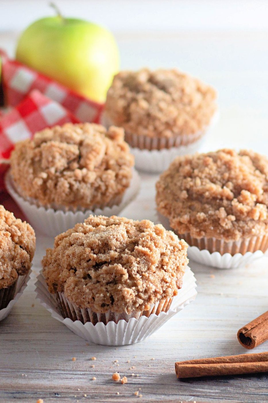 apple muffins on table with green apple in background 