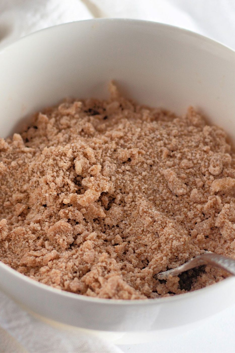 brown sugar crumble topping in a bowl with fork in it