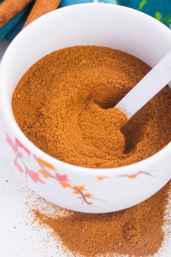 apple spice in a white jar with spoon