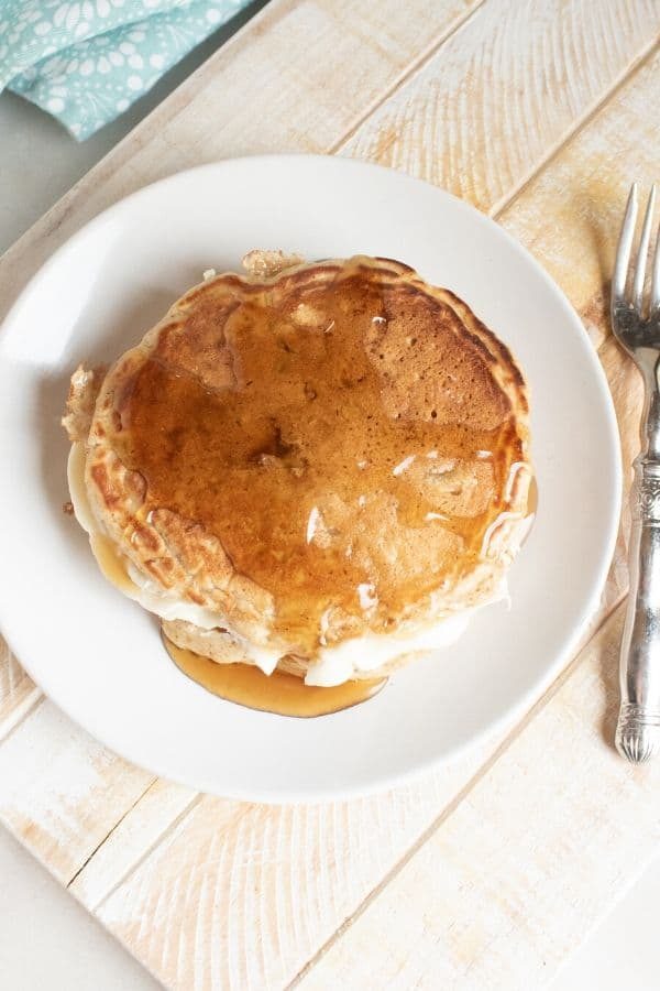 overhead shot of pancakes with syrup on it