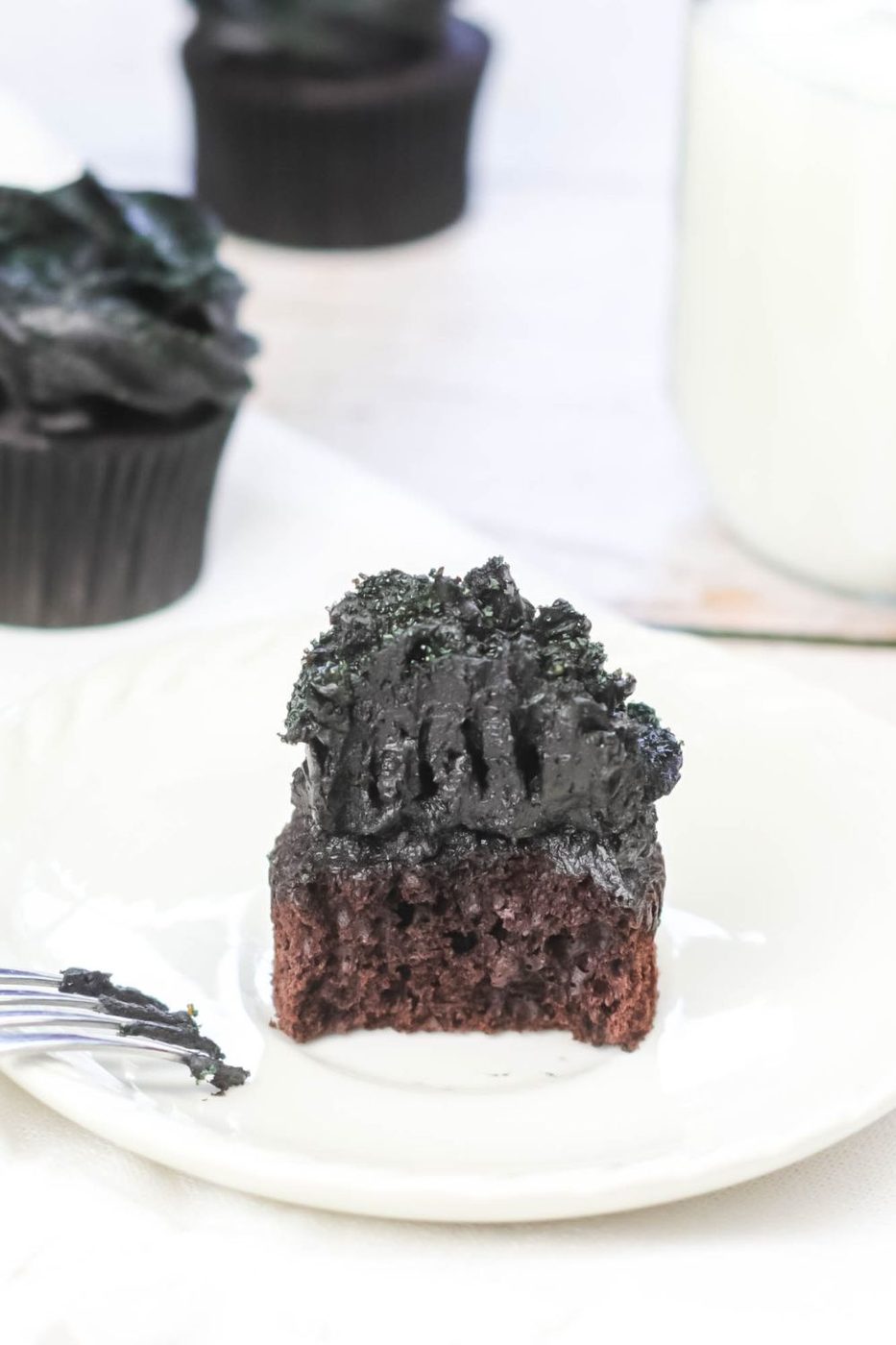 cupcake on a plate with bite taken out of it