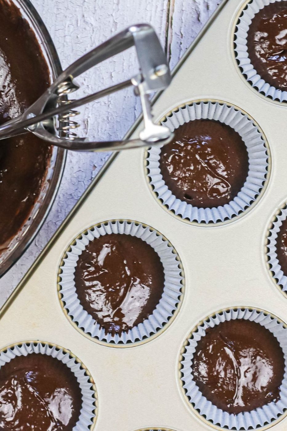chocolate cupcake batter in muffin tin