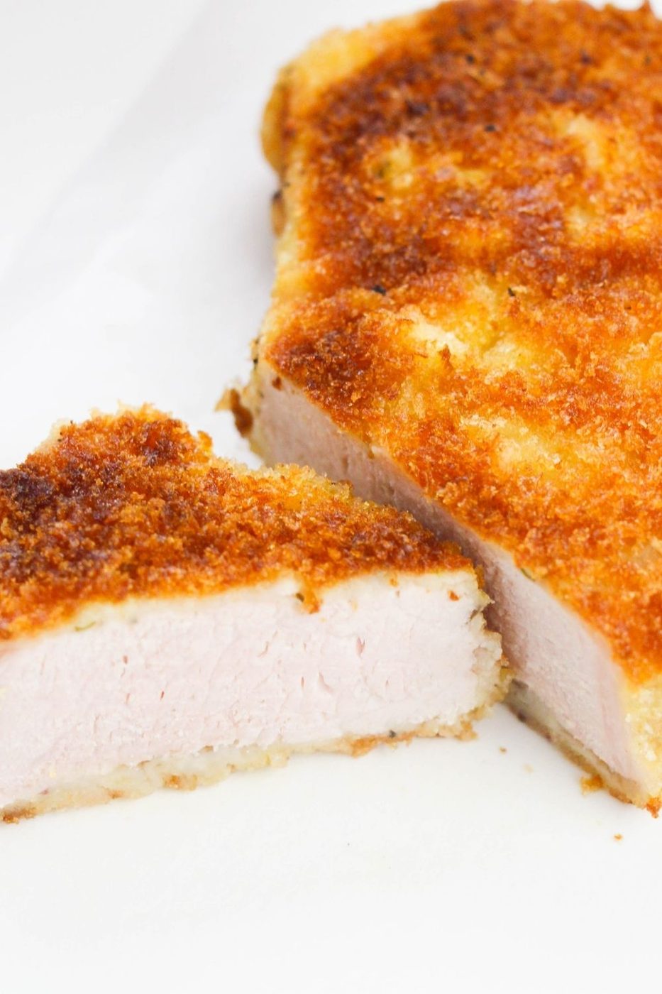sliced pork chop on white table