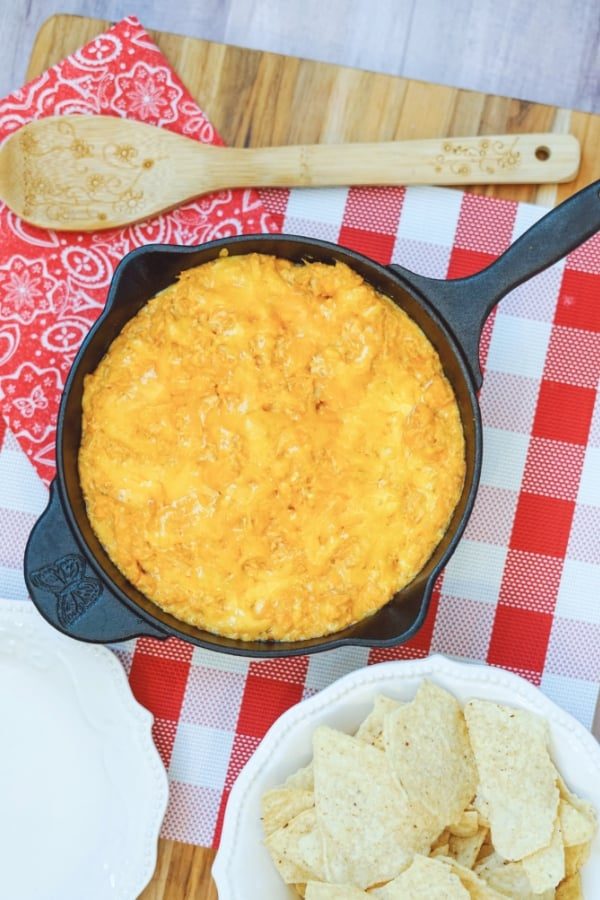 best buffalo chicken dip in a pan with chips by it and a spoon