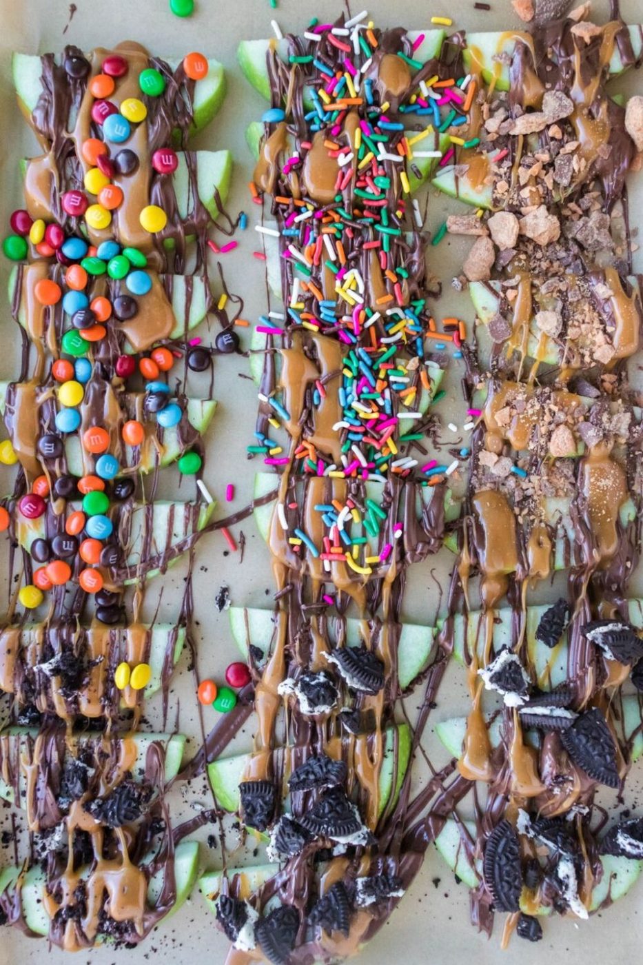 sliced caramel apples topped with sprinkles, crushed cookies, mini M&M's, etc.