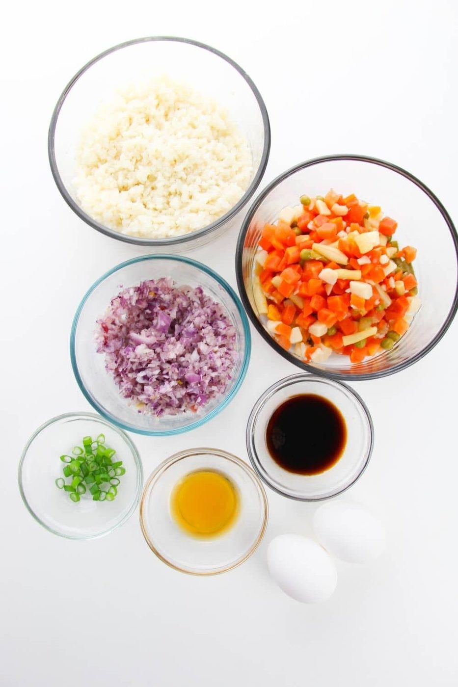 ingredient for cauli rice all in glass bowls on counter
