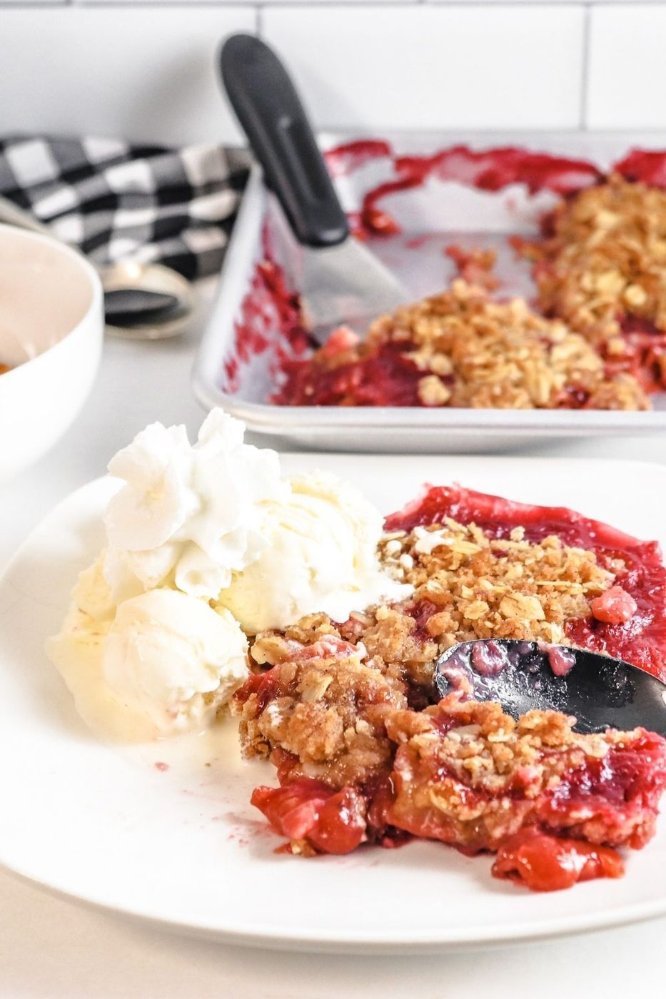 cherry crisp on plate with ice cream on it 