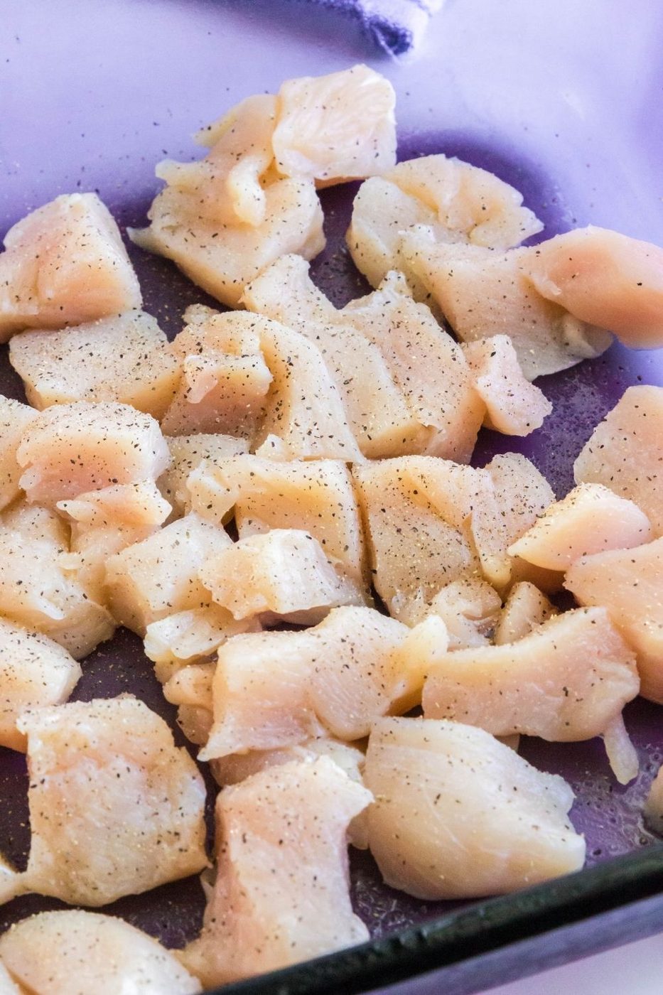 diced boneless chicken in blue casserole dish