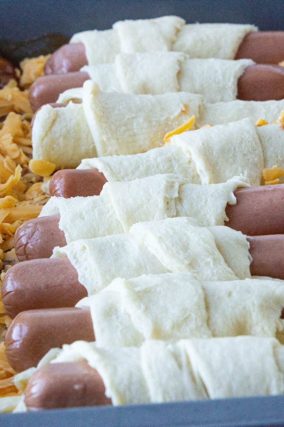 pigs in a blanket on top of cheese and chili
