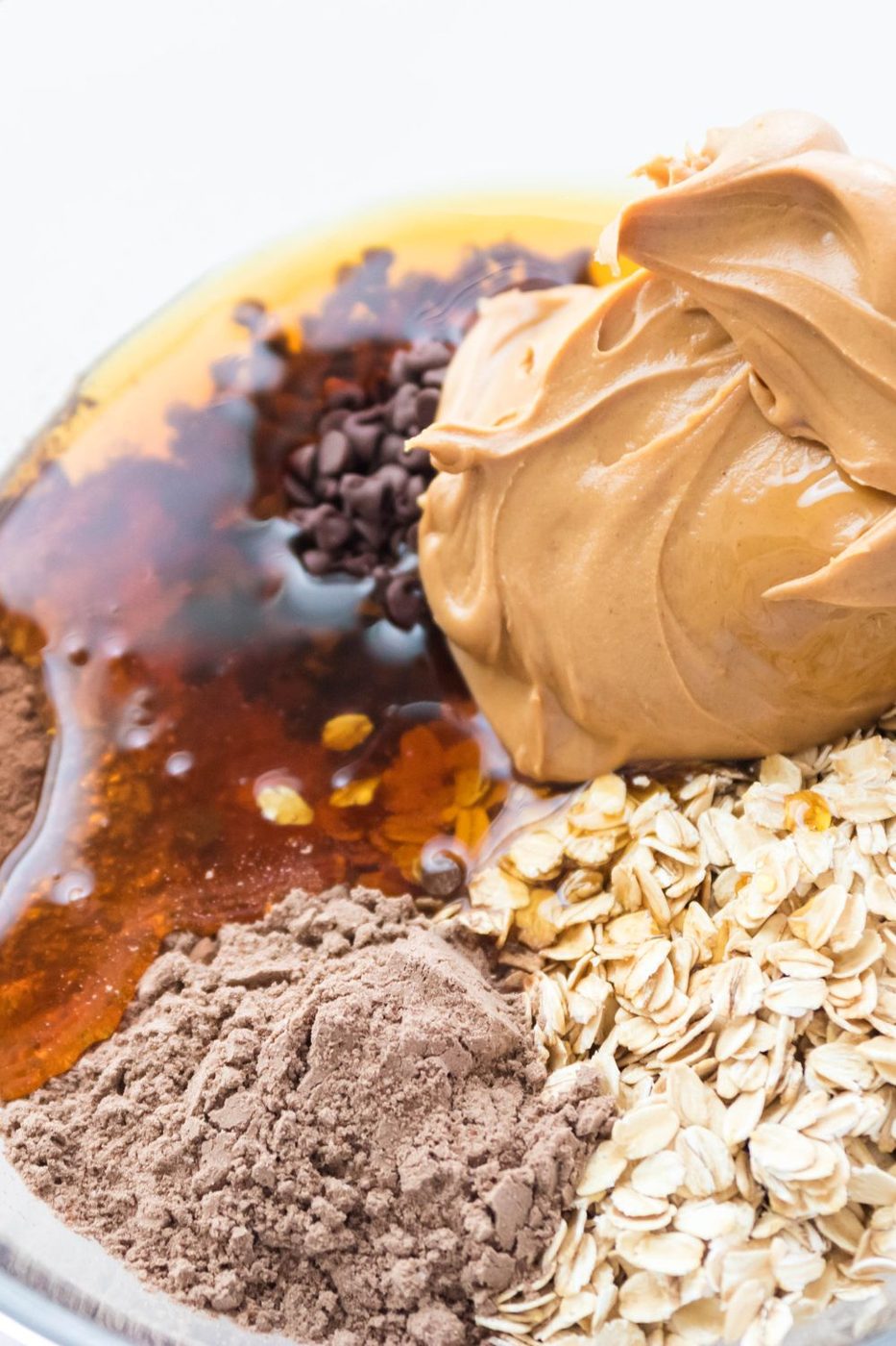 chocolate chip protein ball ingredients in a glass bowl on table 