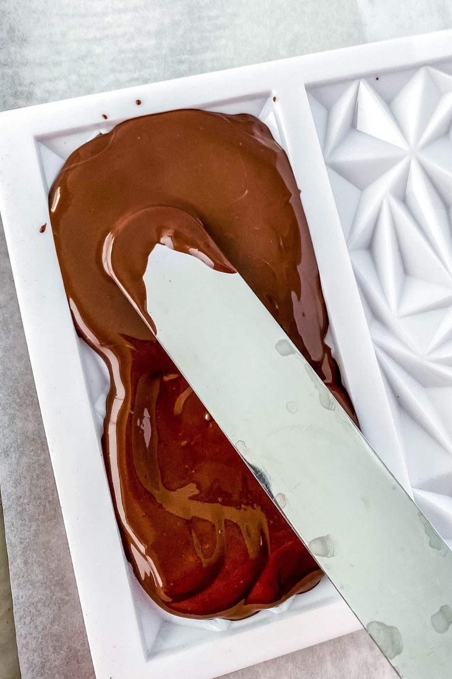 spreading chocolate in the mold