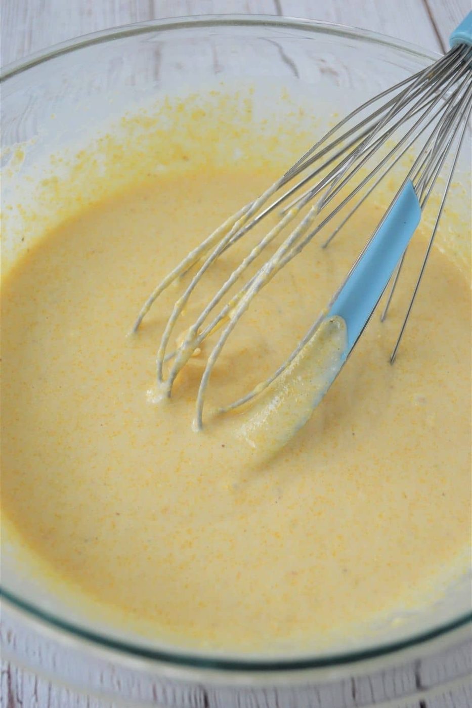 cornmeal flapjacks batter in a bowl with whisk