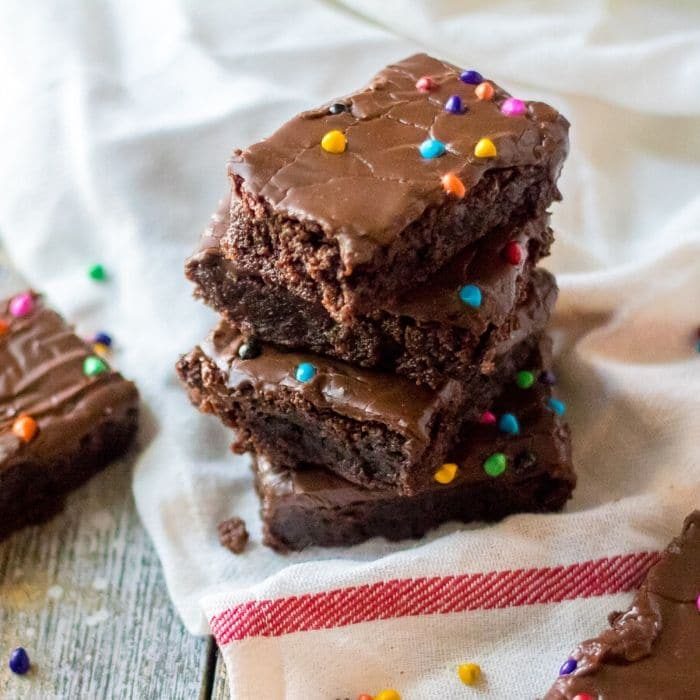cosmic brownies stacked on top of each other on a towel on table