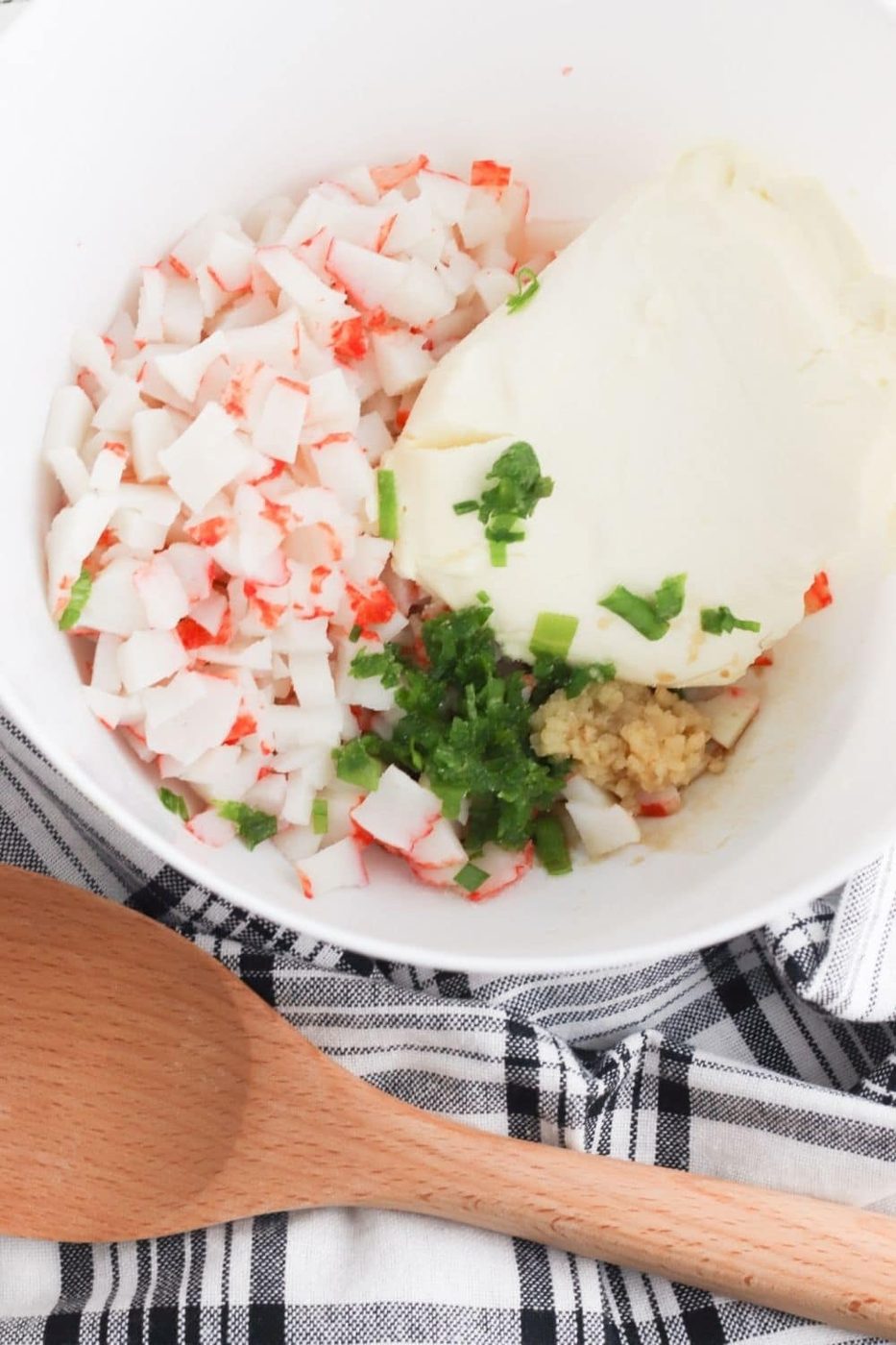 crab rangoon ingredients in a bowl with spoon by it