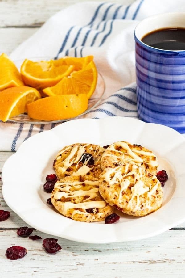 plate of cookies, orange slices and coffee by it