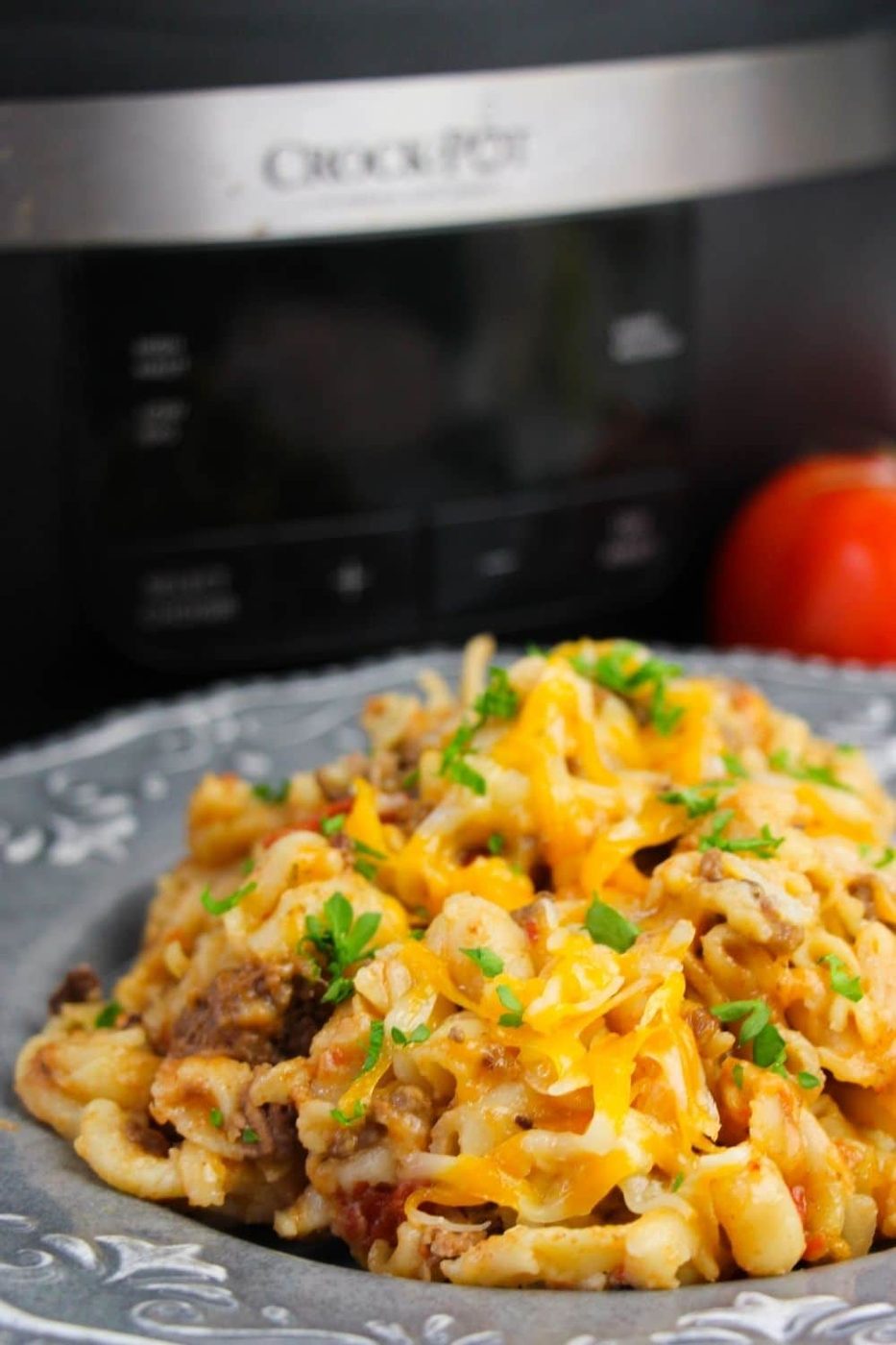 hamburger helper on a plate with crock pot behind it
