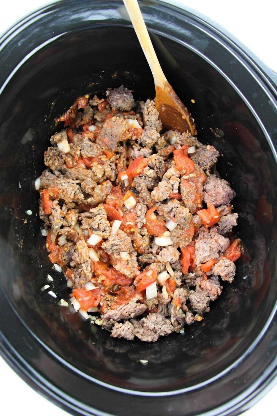 hamburger, onion, garlic, all in crock pot overhead camera shot