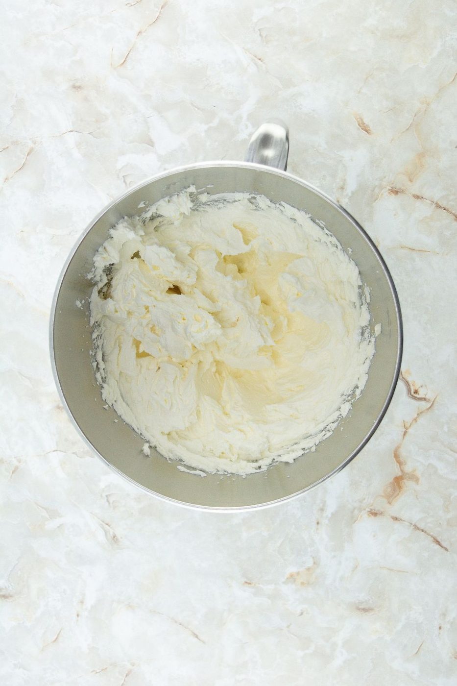 homemade buttercream frosting in mixing bowl 