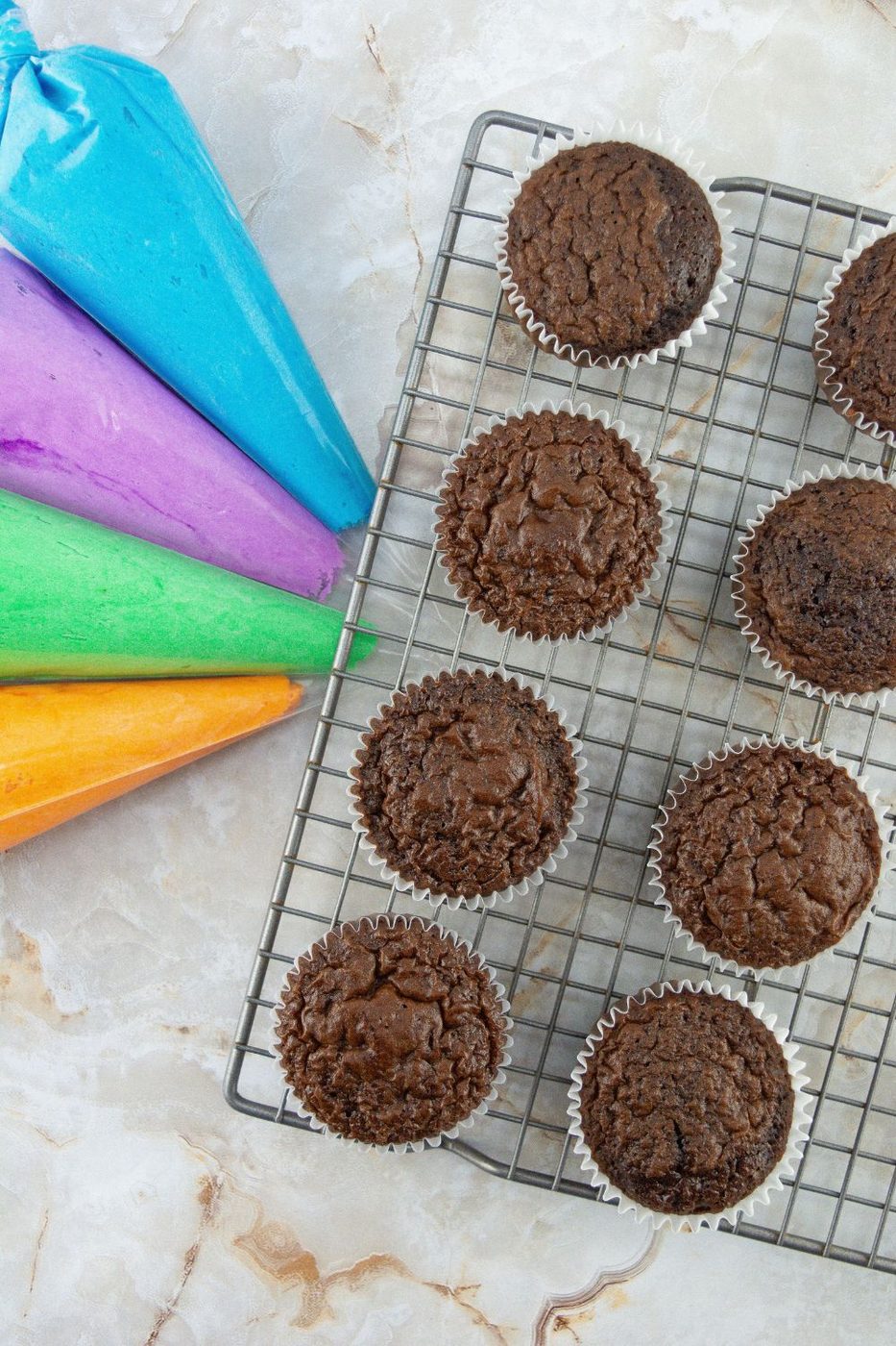 frosting and cupcakes on wire rack