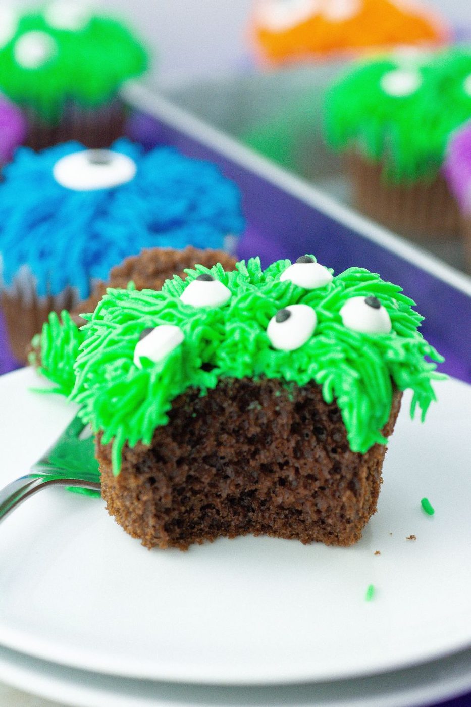 bite taken out of cupcake sitting on plate 