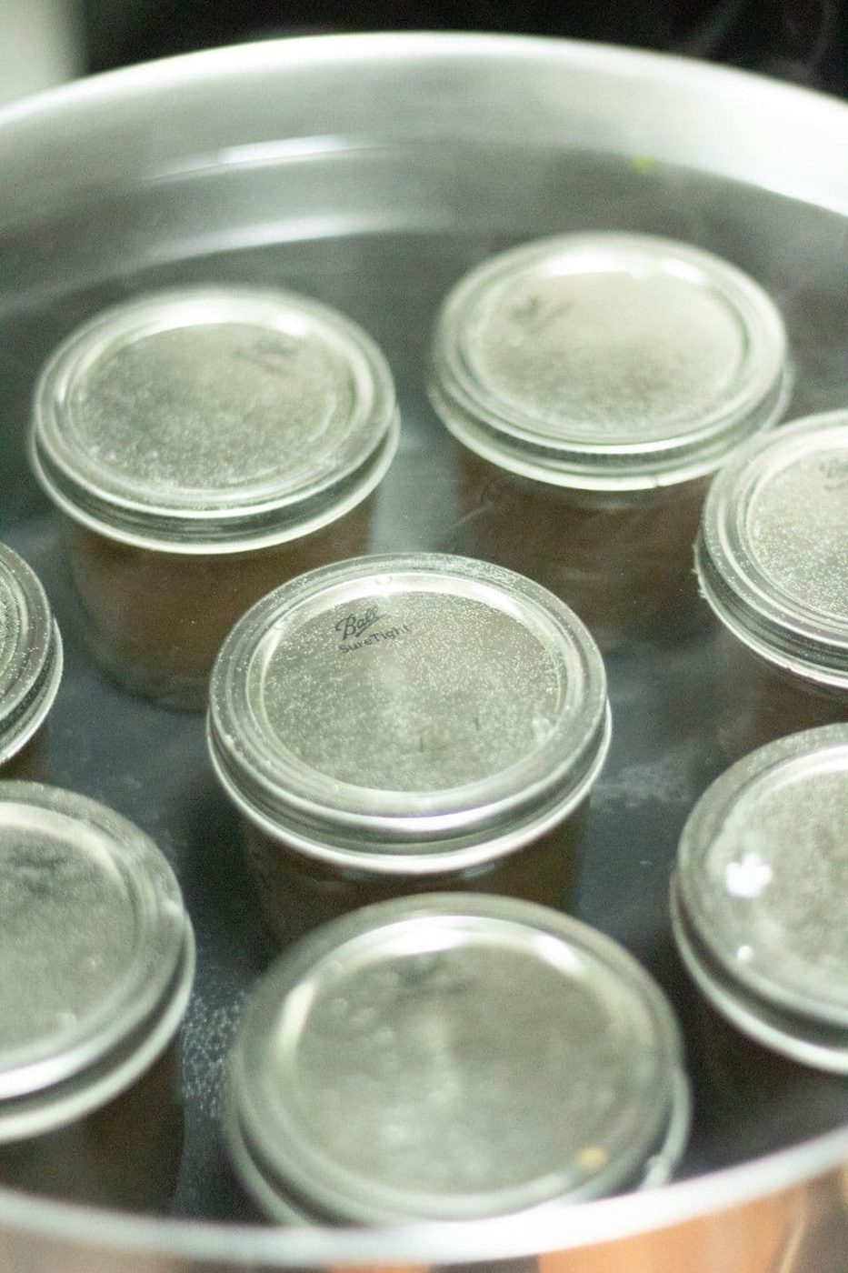 flower jelly in jars in a canning pot