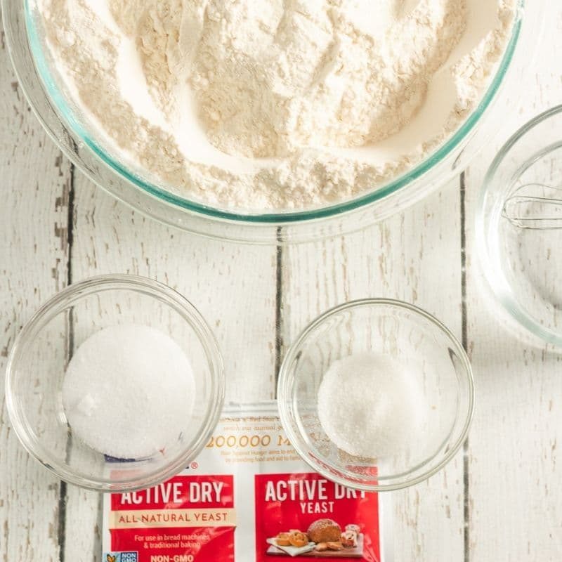 ingredients for making bread on white wood table
