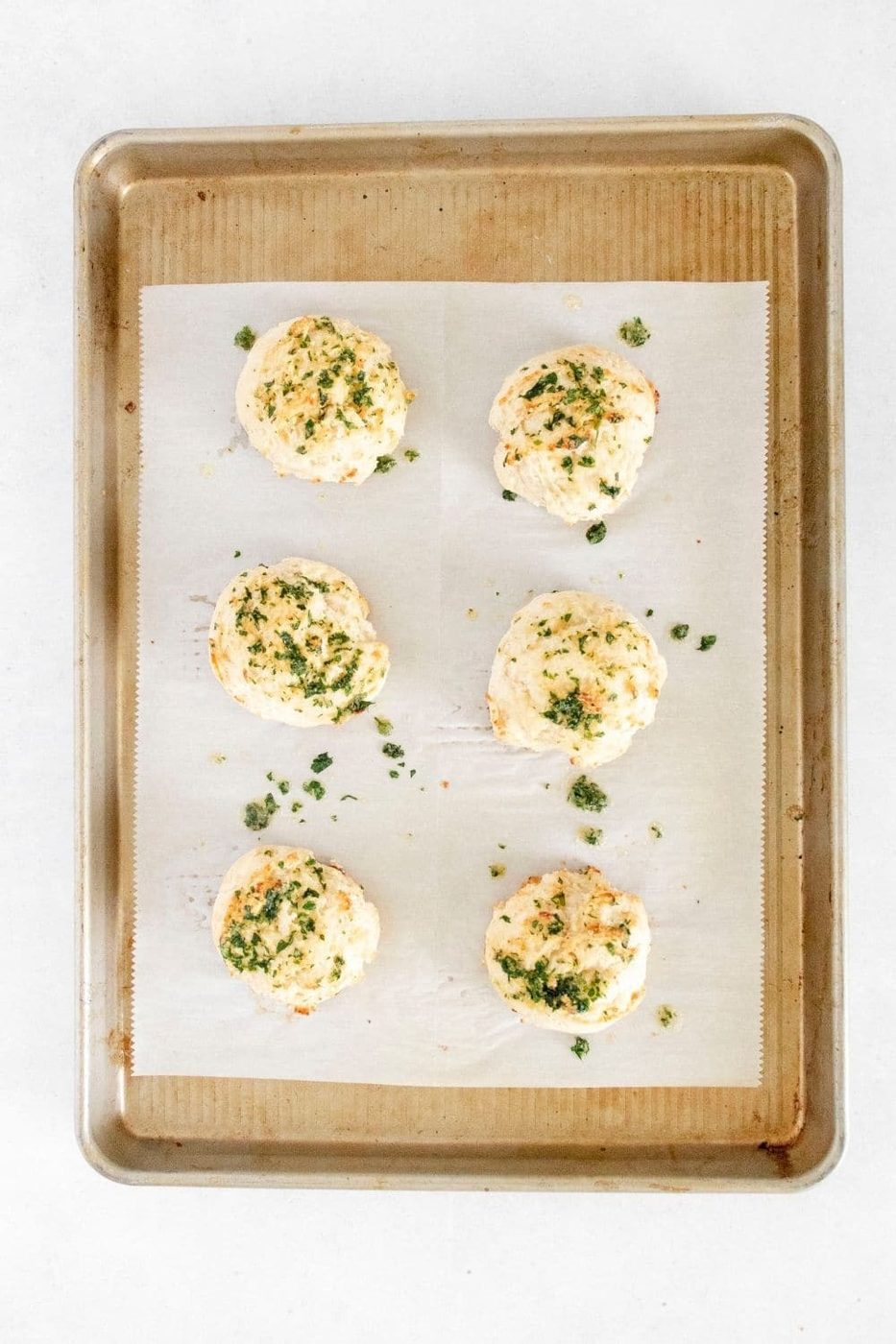 parmesan biscuits on a baking sheet