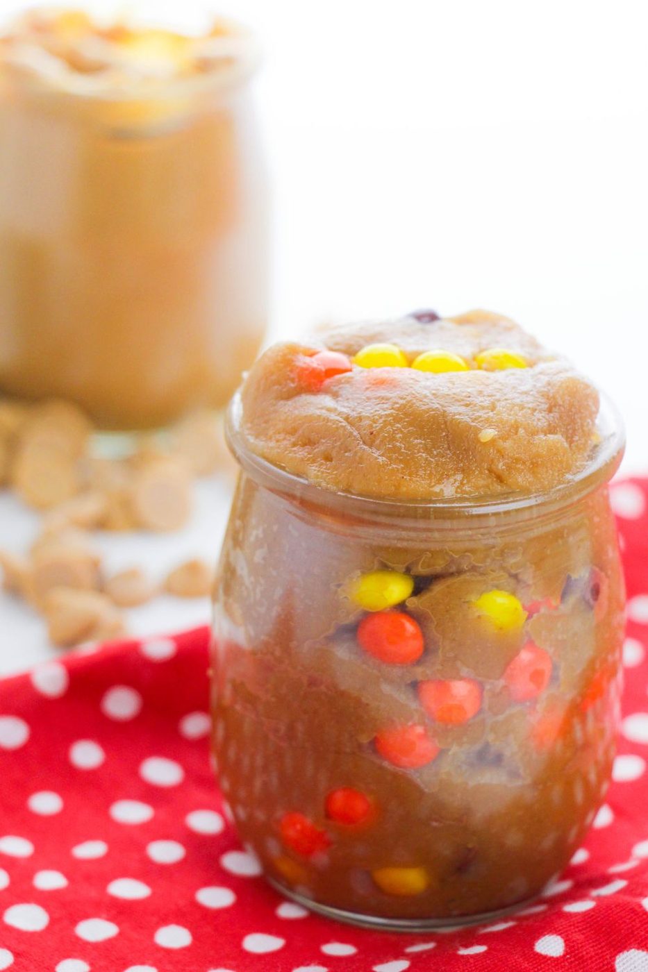 edible cookie dough in a jar with Reese's Pieces in it 