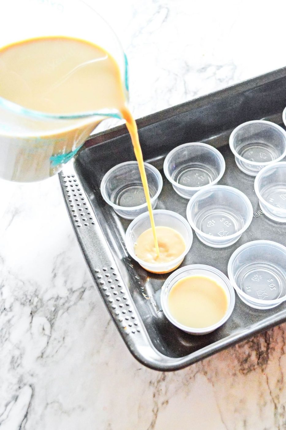 pouring jello shots into cups