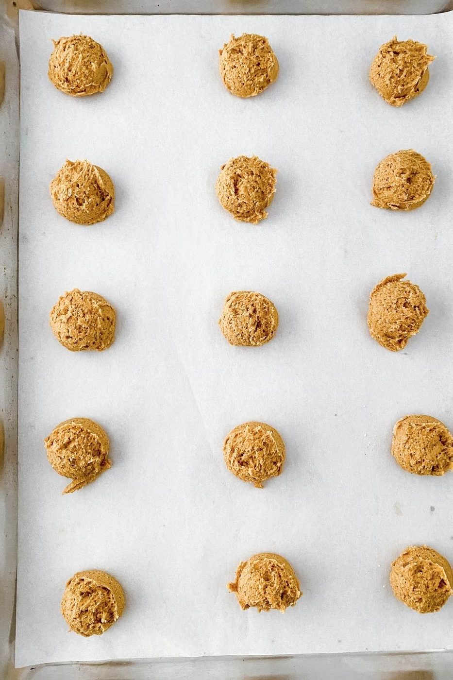 gingersnap cookie dough on baking sheet rolled in balls