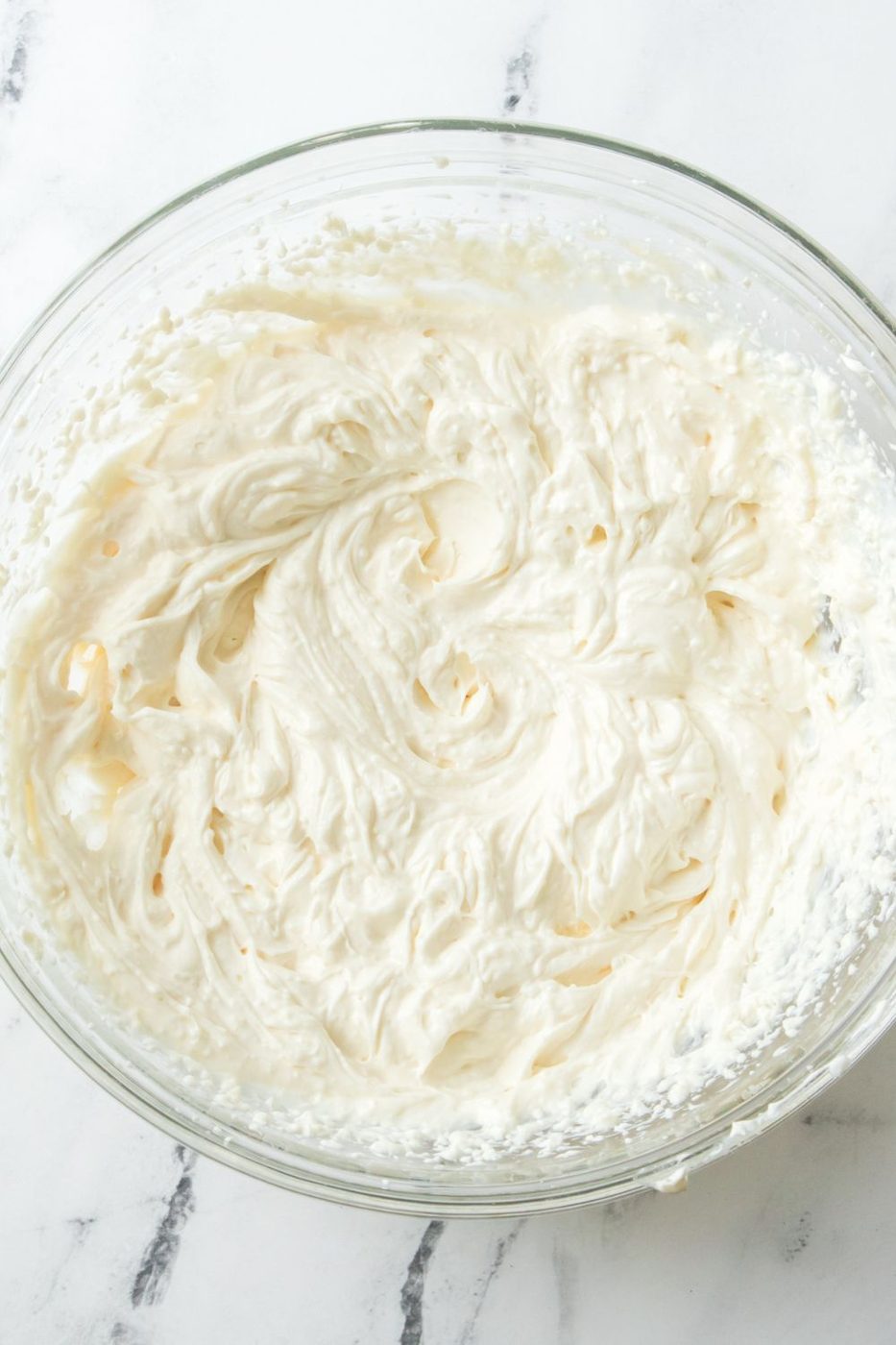 cream cheese, sour cream and sugar mixed together in a bowl 