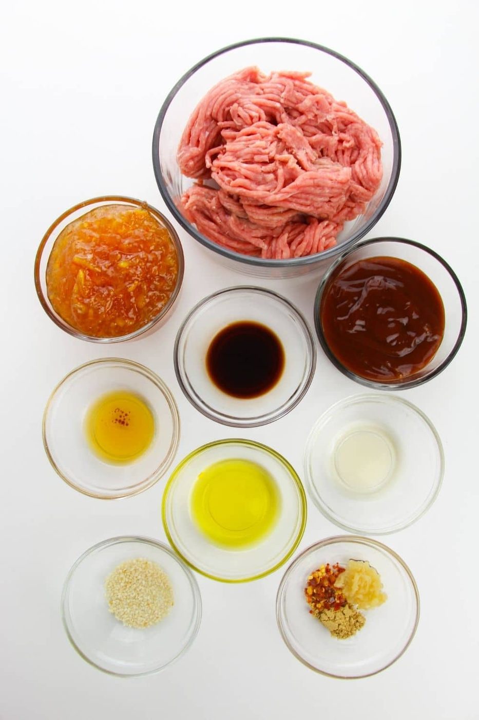 ground chicken and other ingredients for orange chicken on white table 