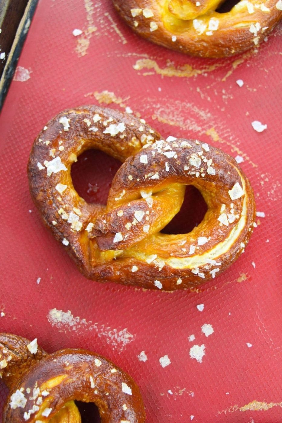 pretzels on a red silicone baking mat