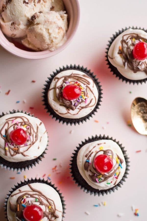 cupcakes for parties on counter with ice cream behind it