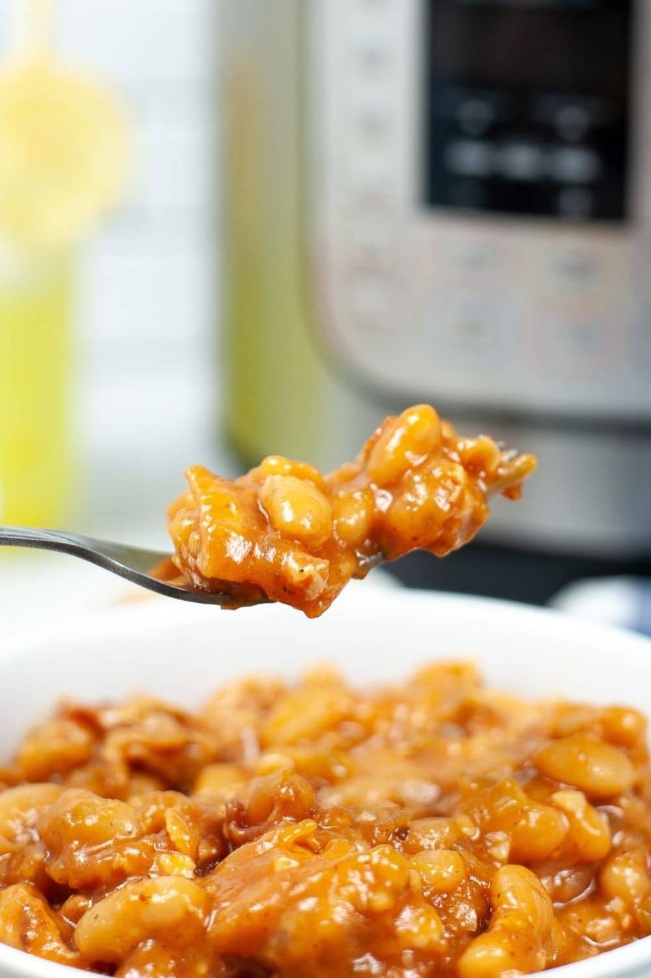 baked beans on a fork above bowl