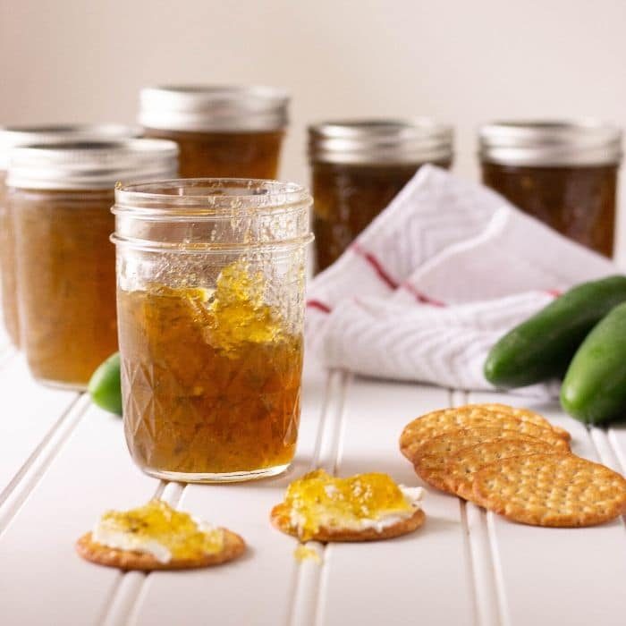 easy pepper jelly in a jar with crackers in front