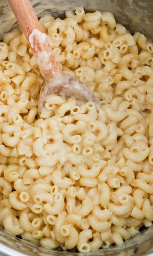 homemade mac and cheese in instant pot with wooden spoon