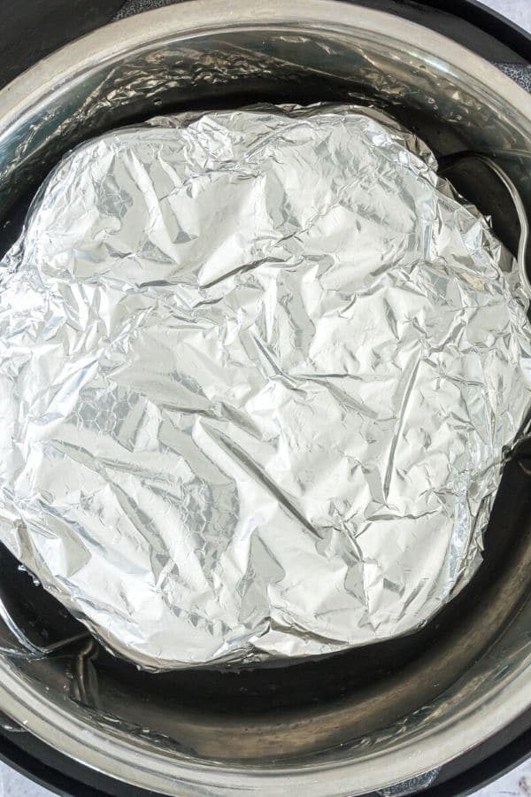egg bite mold covered in aluminum foil in Instant Pot