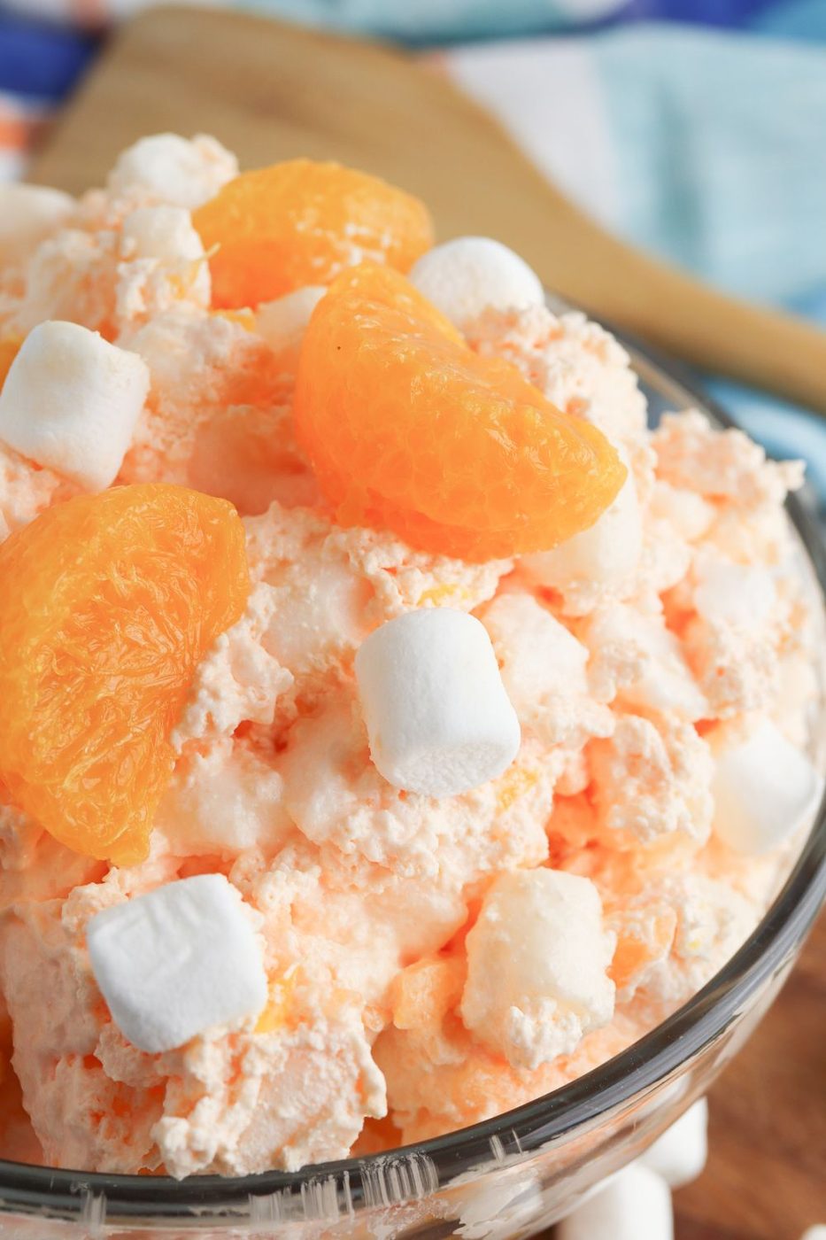 side view of orange fluff salad in a glass bowl 