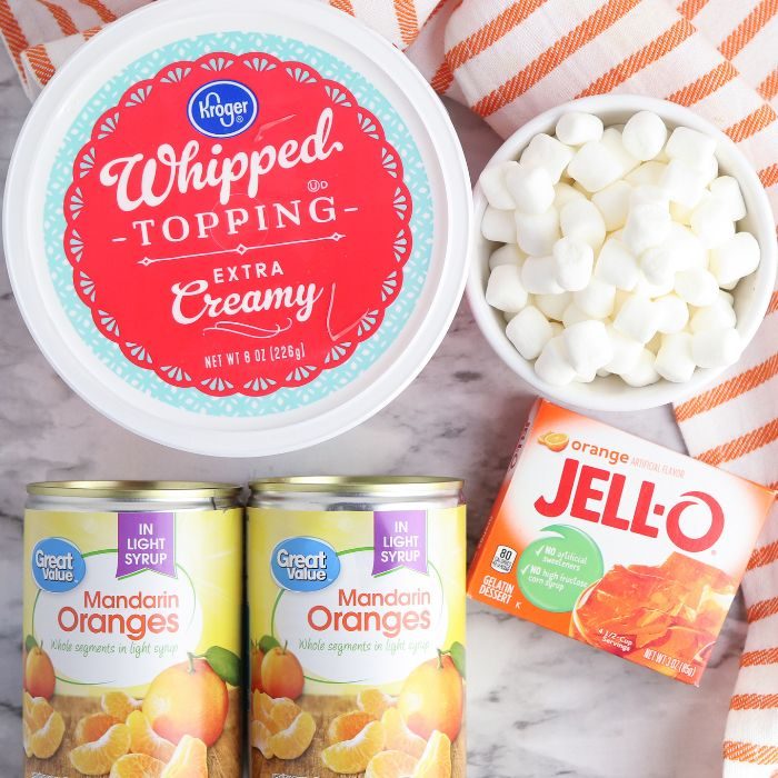 ingredients for orange fluff salad on marble counter 