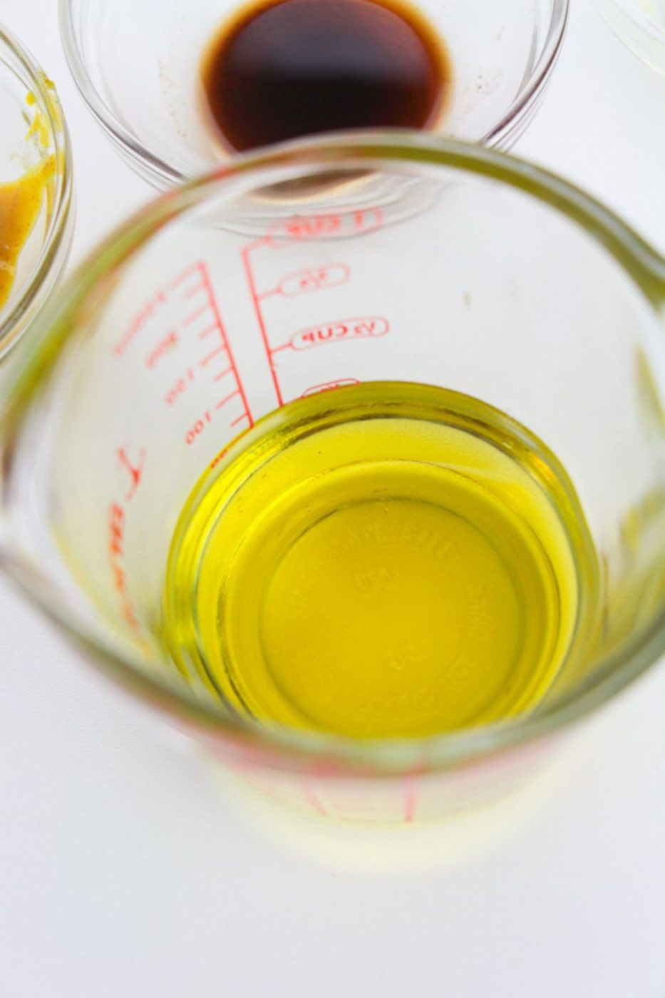 oil in a measuring cup on a white table 