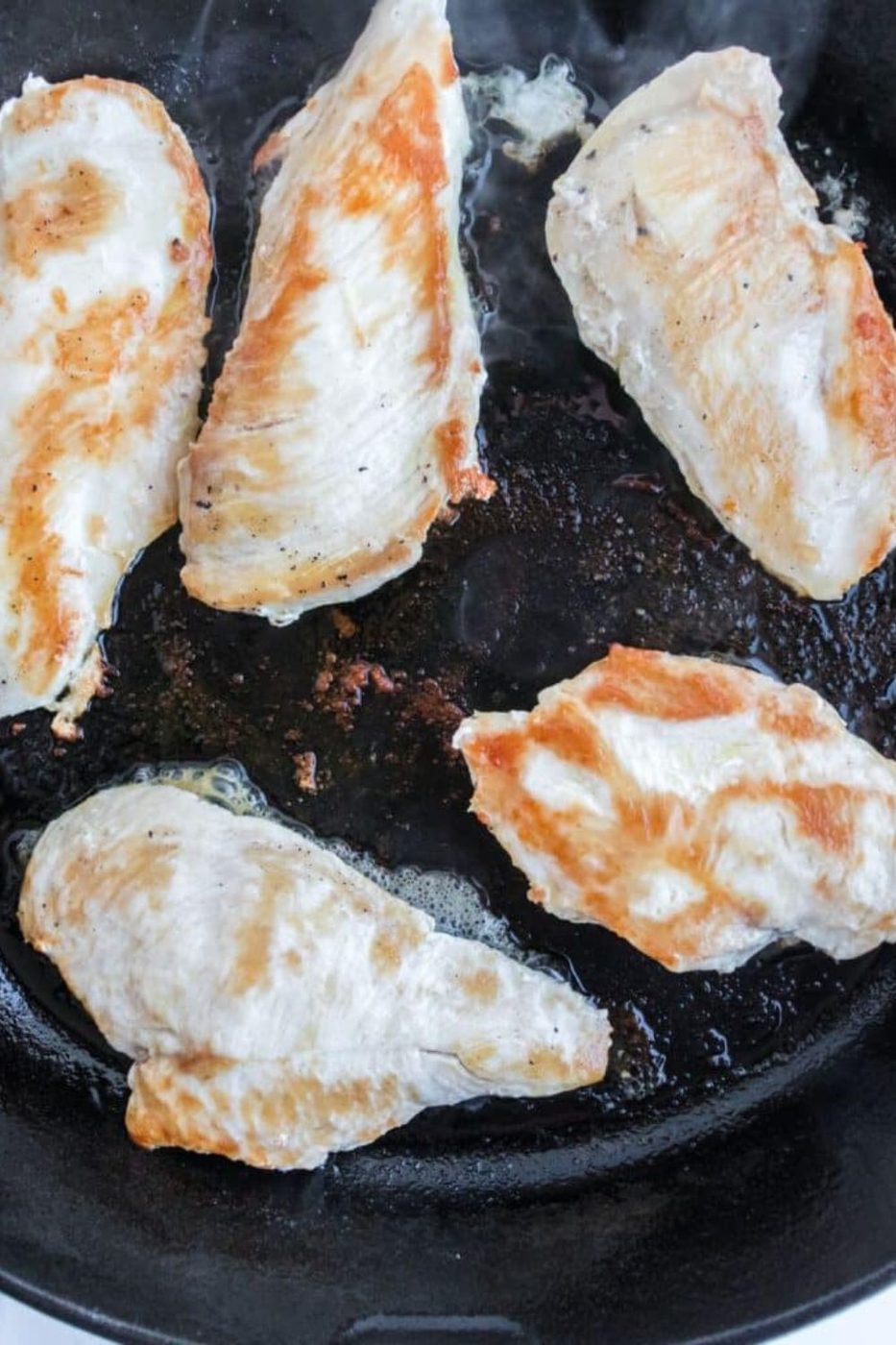 searing chicken in a cast iron skillet 