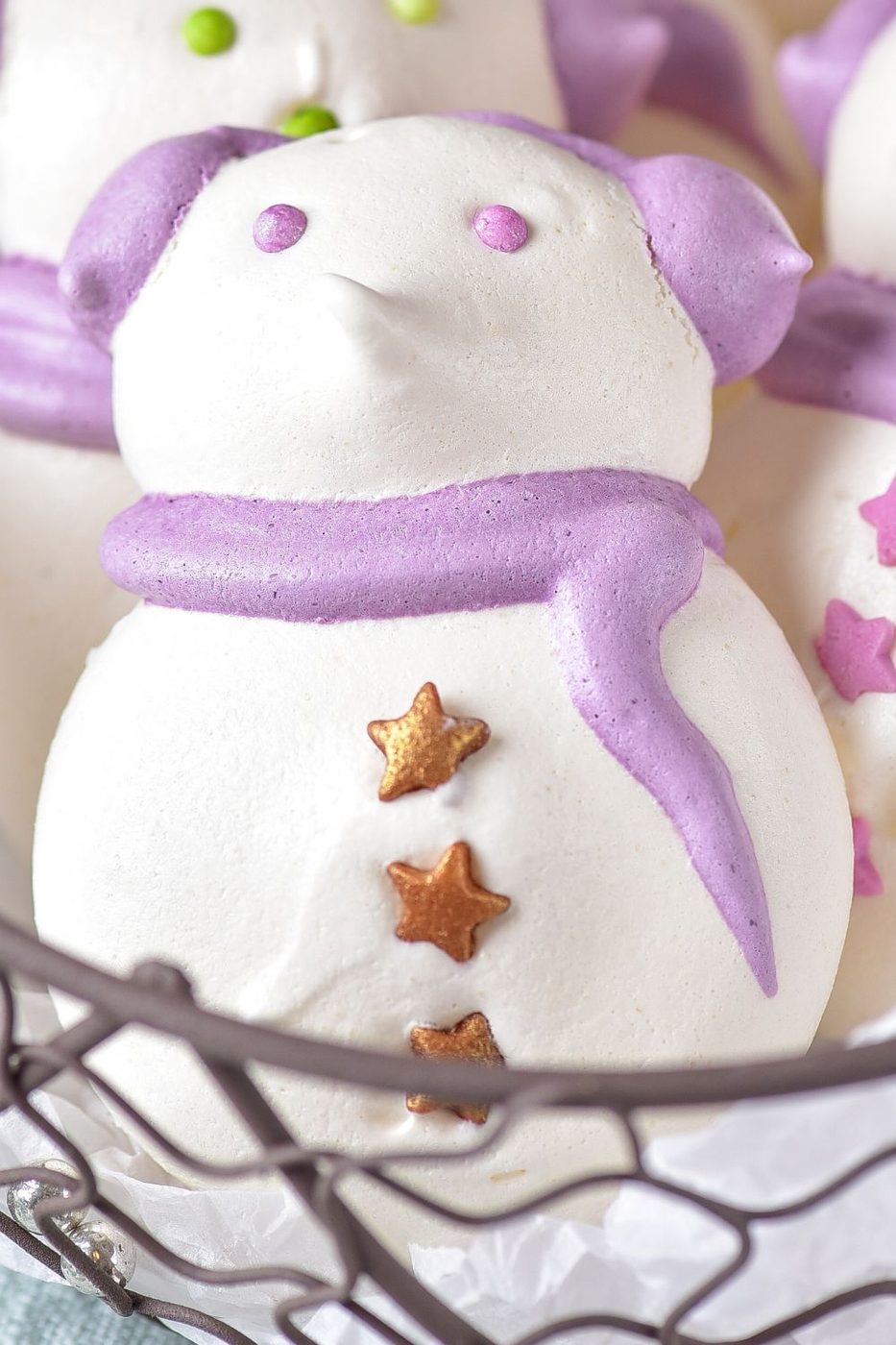 close up of meringue cookie in a wire basket 