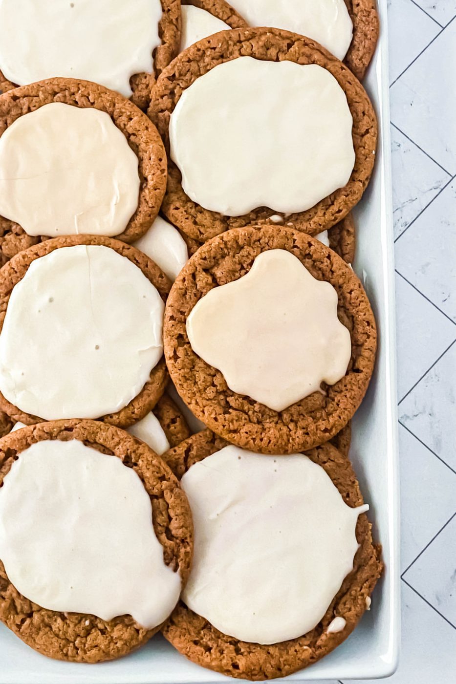 molasses cookies frosted on baking tray