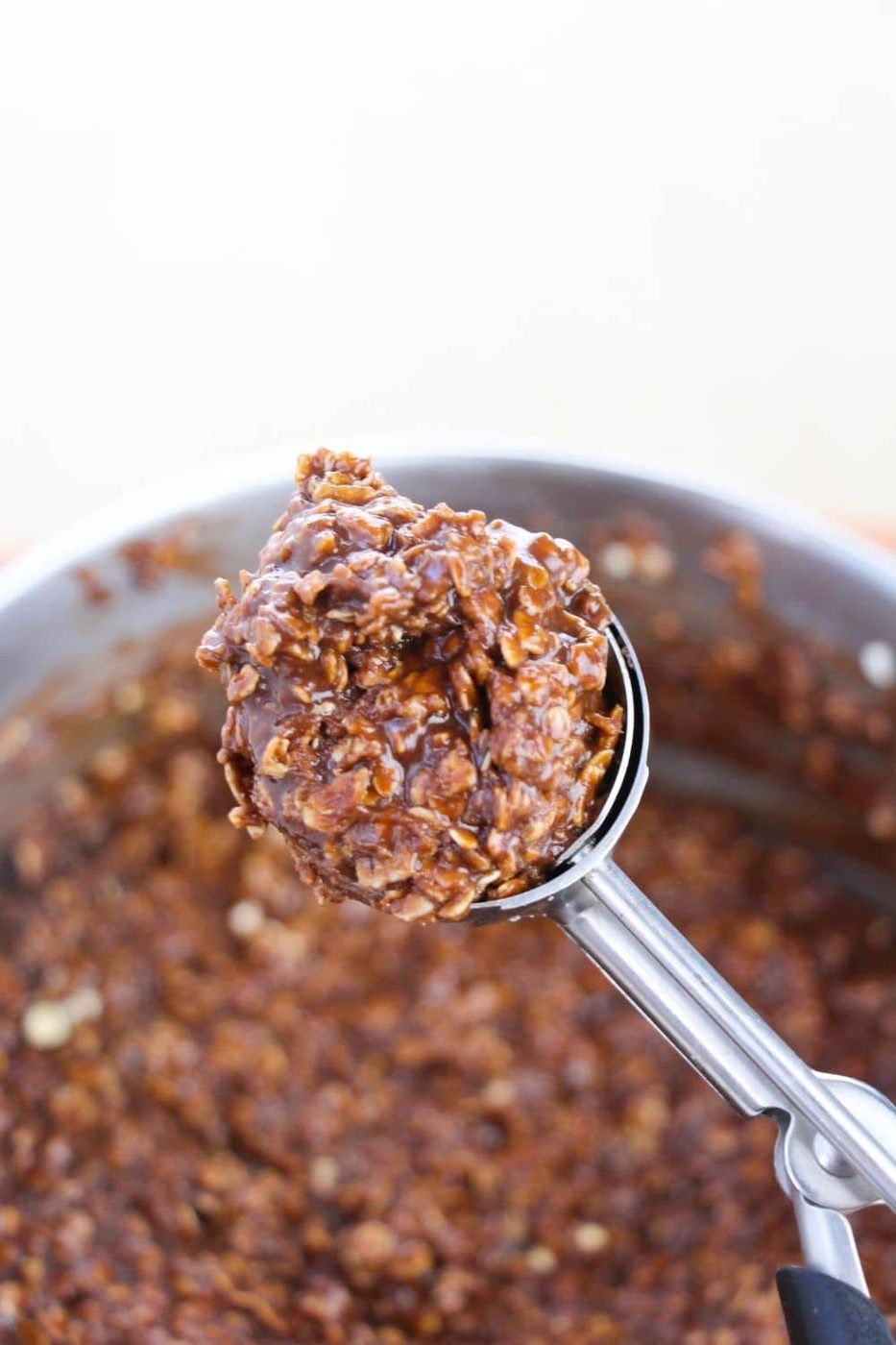 oatmeal no bake cookie on a cookie scoop above pot